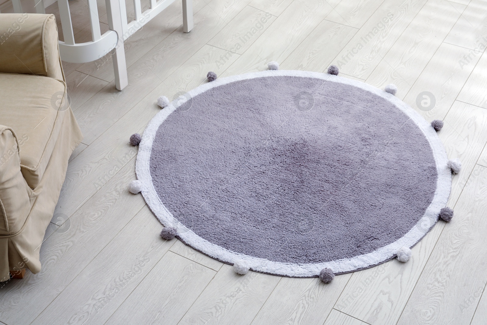 Photo of Stylish soft rug on floor in room