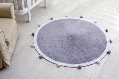 Photo of Stylish soft rug on floor in room