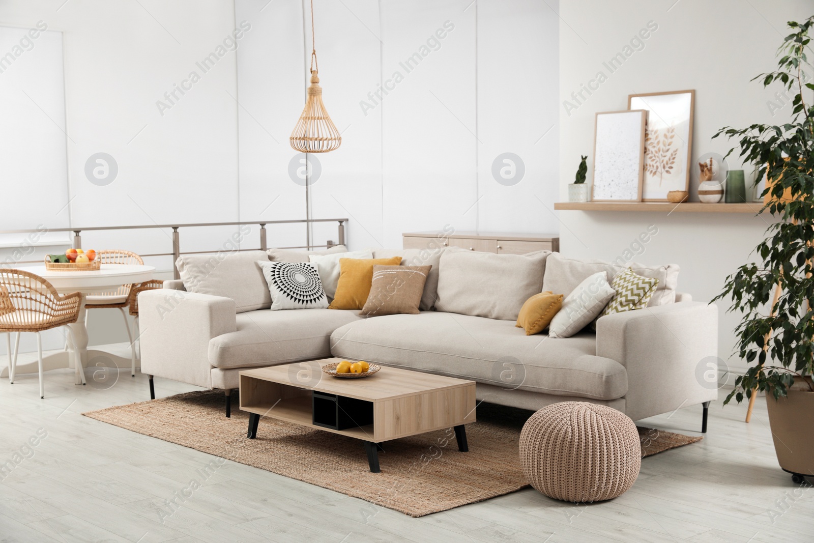 Photo of Stylish living room interior with comfortable grey sofa and coffee table