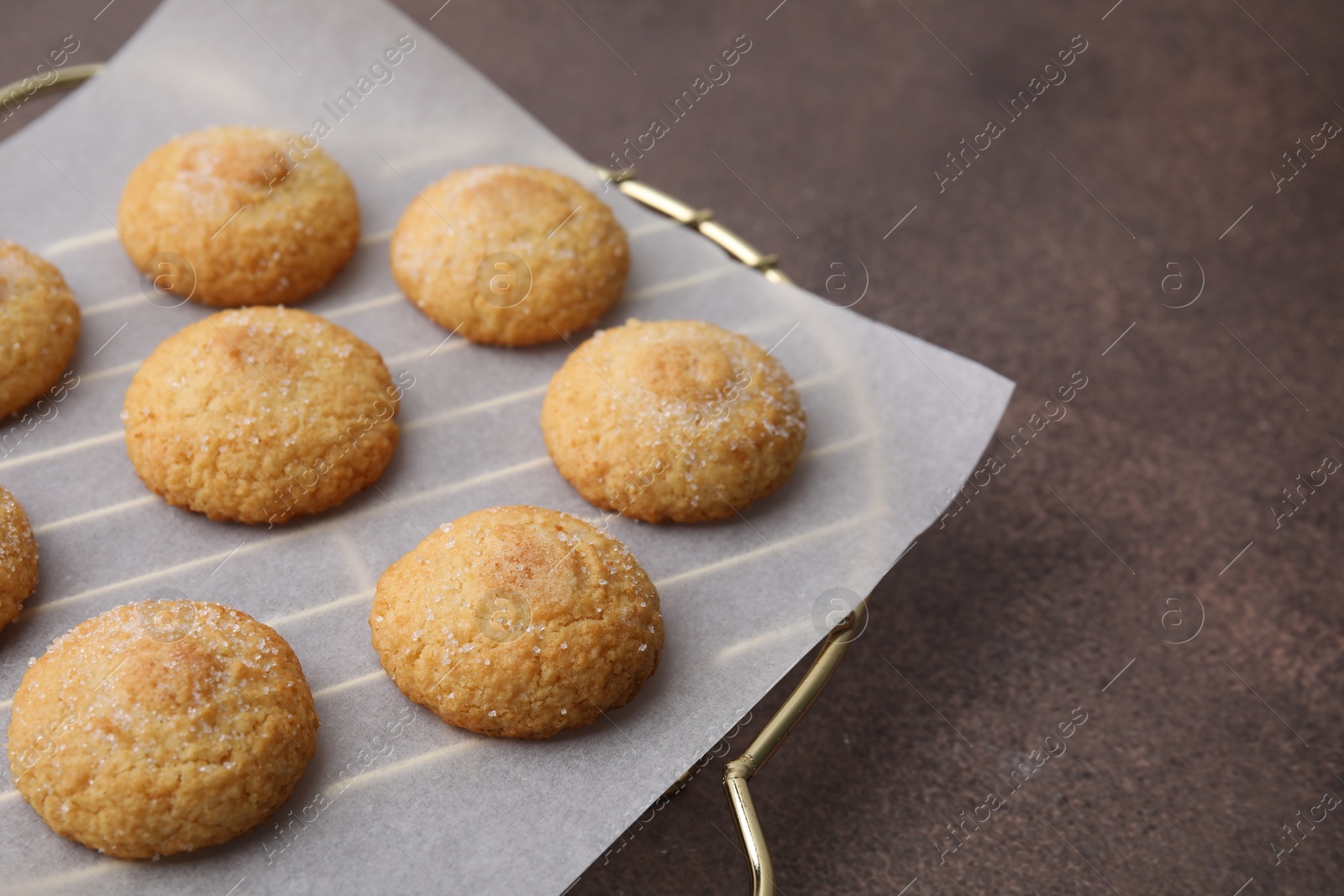 Photo of Tasty sweet sugar cookies on brown table, closeup. Space for text