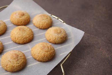 Photo of Tasty sweet sugar cookies on brown table, closeup. Space for text