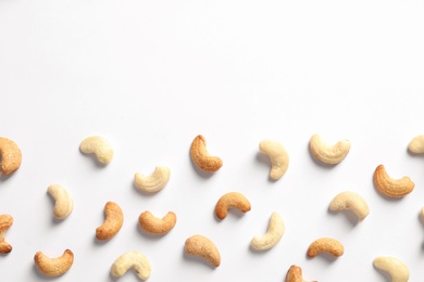 Photo of Tasty cashew nuts isolated on white, top view. Space for text