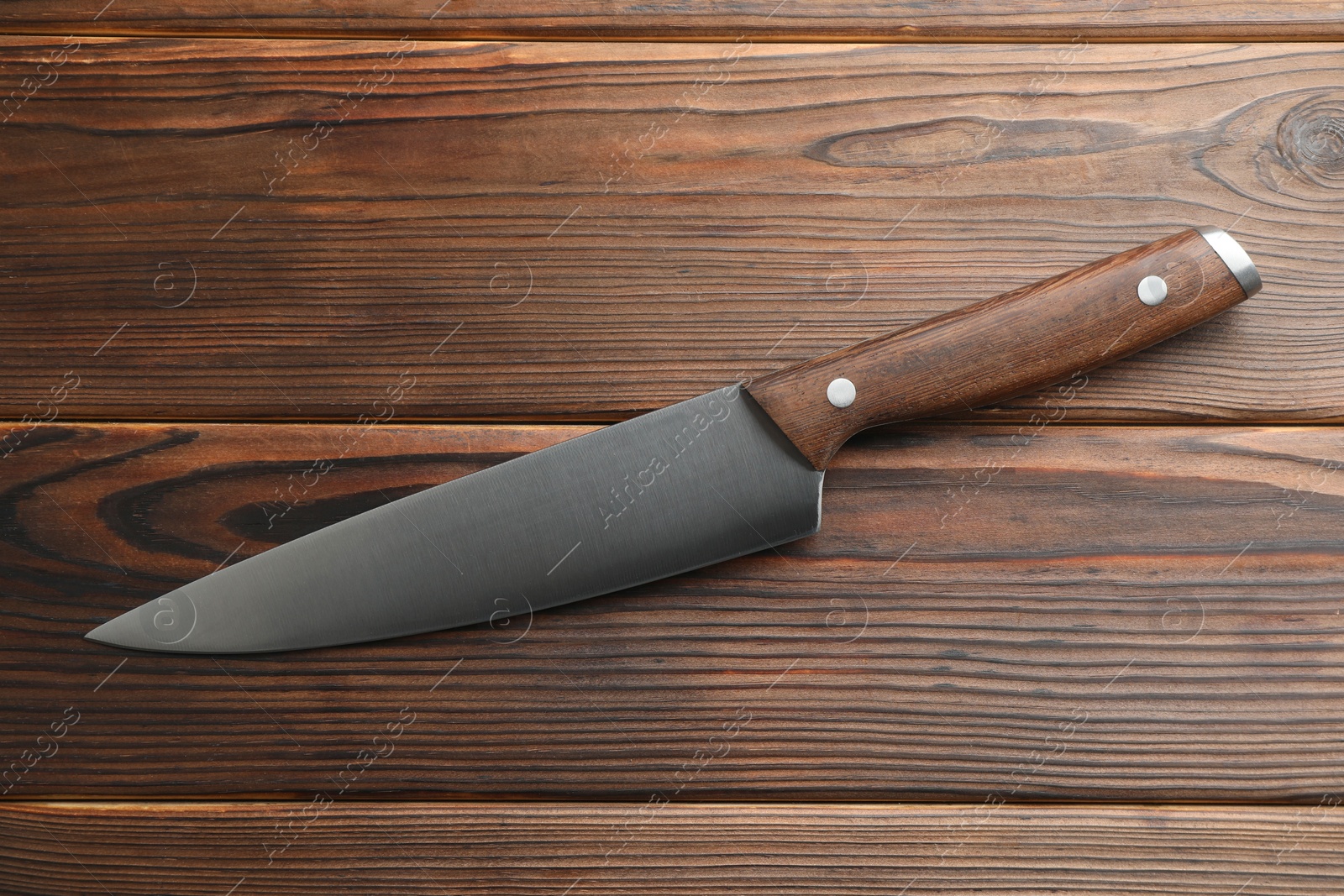 Photo of One knife on wooden table, top view