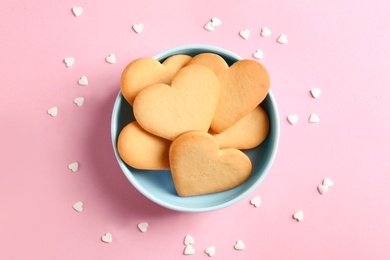 Photo of Flat lay composition with homemade heart shaped cookies on color background