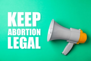 Reproductive rights protest. Megaphone with slogan Keep Abortion Legal on aquamarine color background