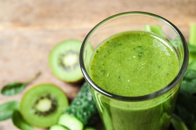 Delicious fresh green juice in glass, closeup. Space for text