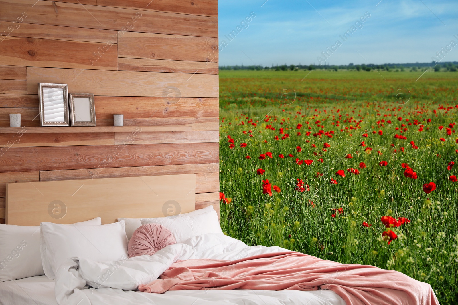 Image of Comfortable bed with soft pillows in in poppy field on sunny day