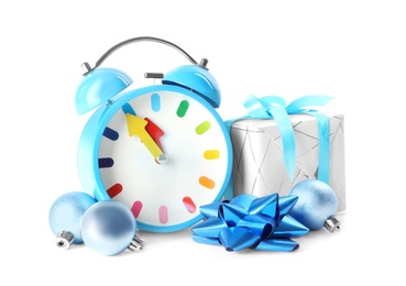 Photo of Alarm clock, gift and festive decor on white background. New Year countdown