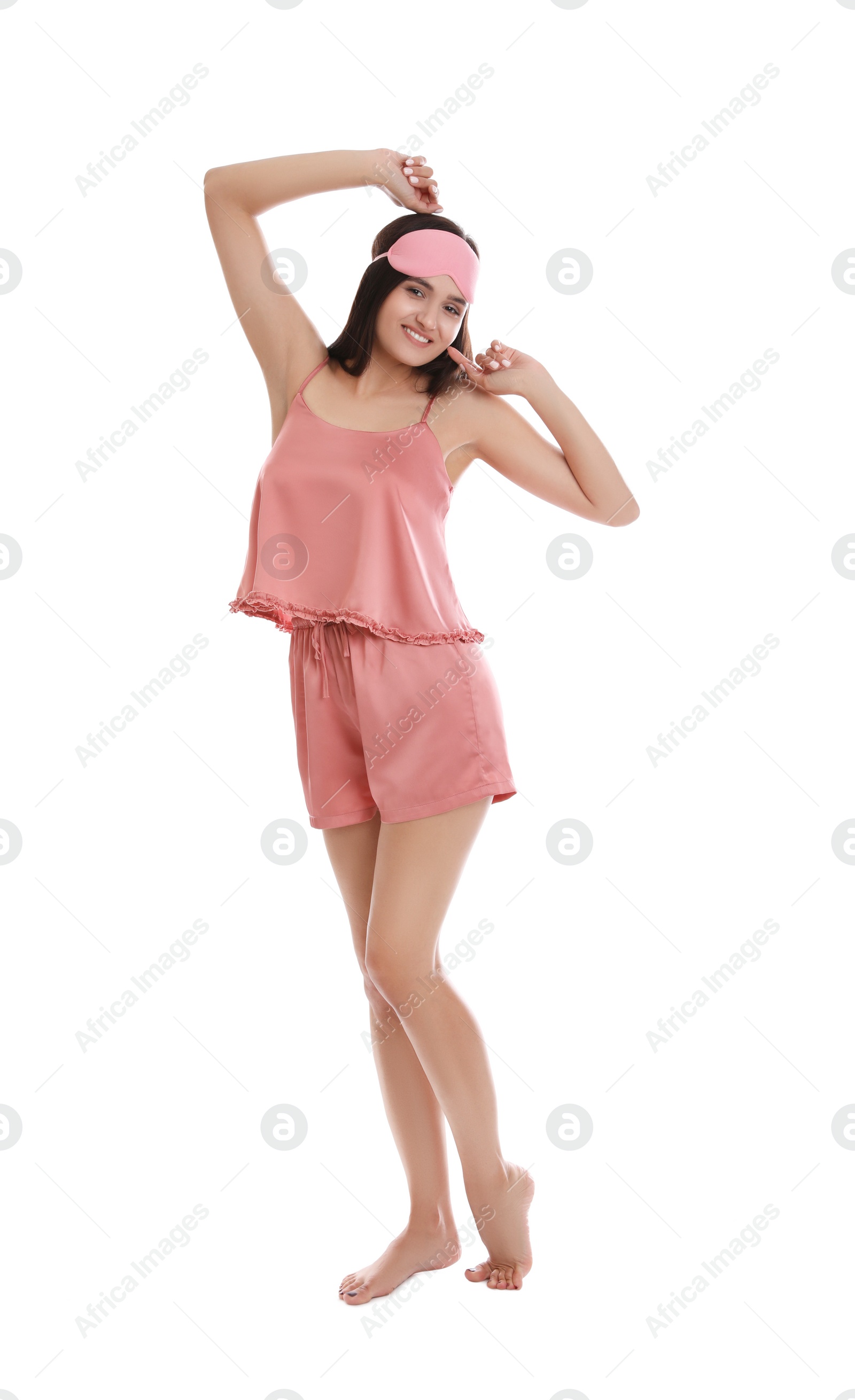 Photo of Beautiful woman wearing sleeping mask on white background. Bedtime