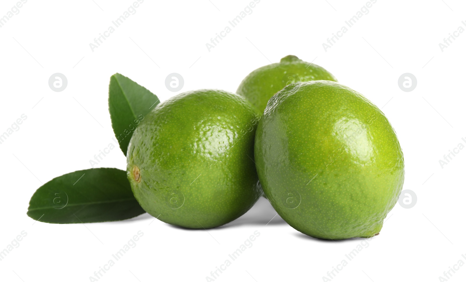 Photo of Fresh ripe limes with green leaves isolated on white