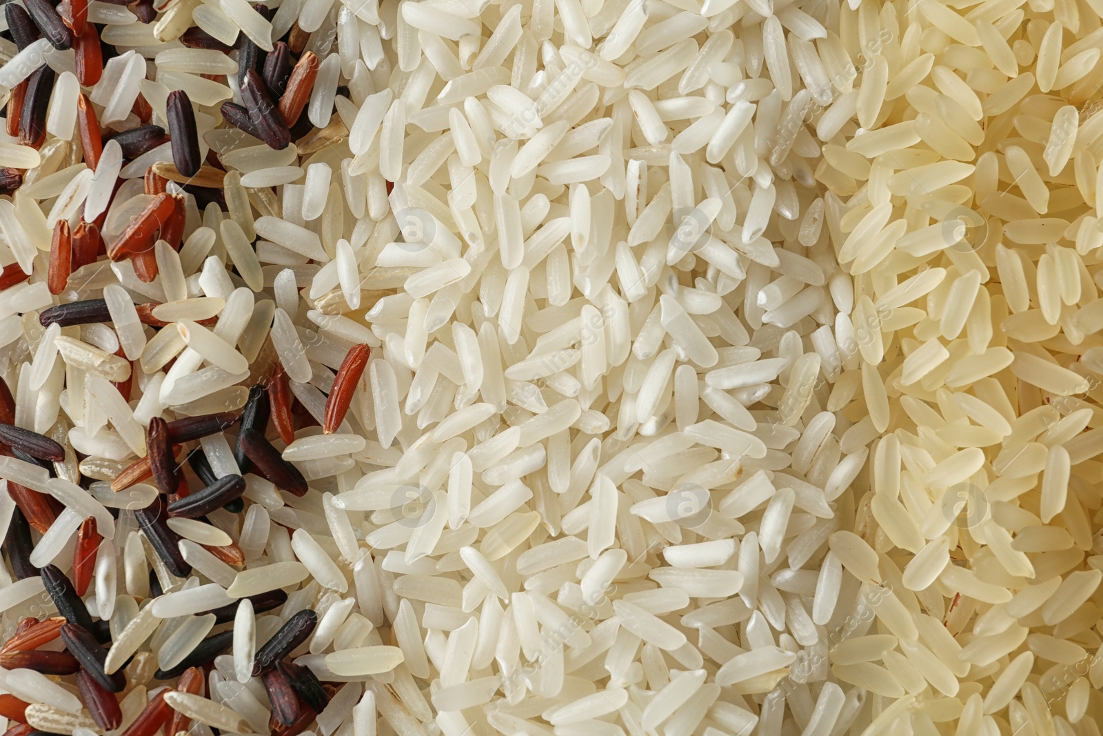 Photo of Brown and other types of rice as background, closeup