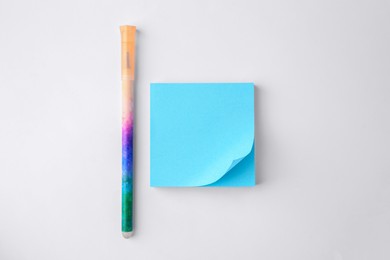Photo of Blank paper note and pen on white background, flat lay