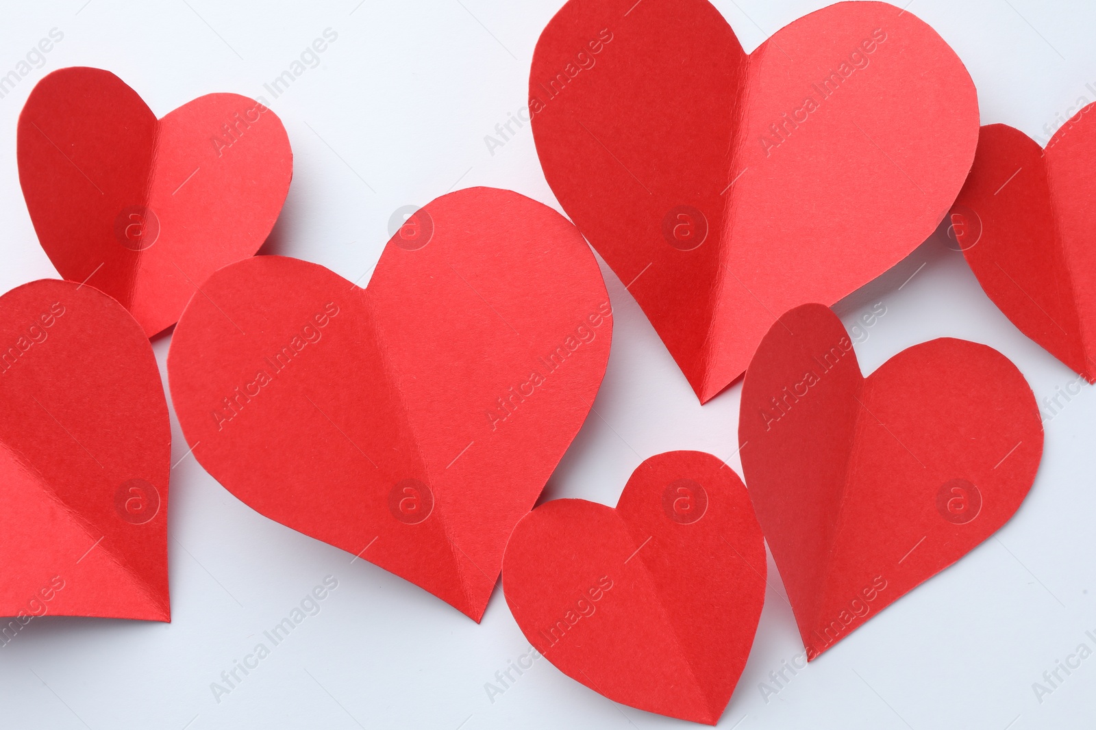 Photo of Paper hearts on white background, flat lay