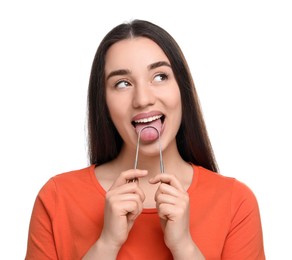 Happy woman brushing her tongue with cleaner on white background