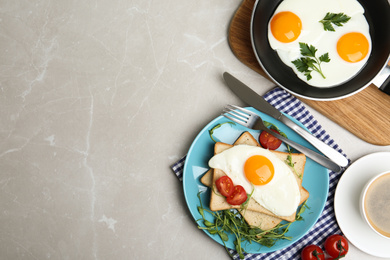 Photo of Flat lay composition with tasty fried eggs on light grey marble table. Space for text