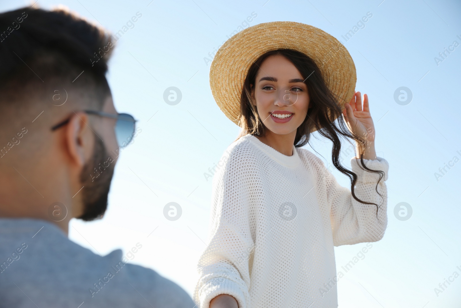 Photo of Happy young couple against blue sky. Honeymoon trip