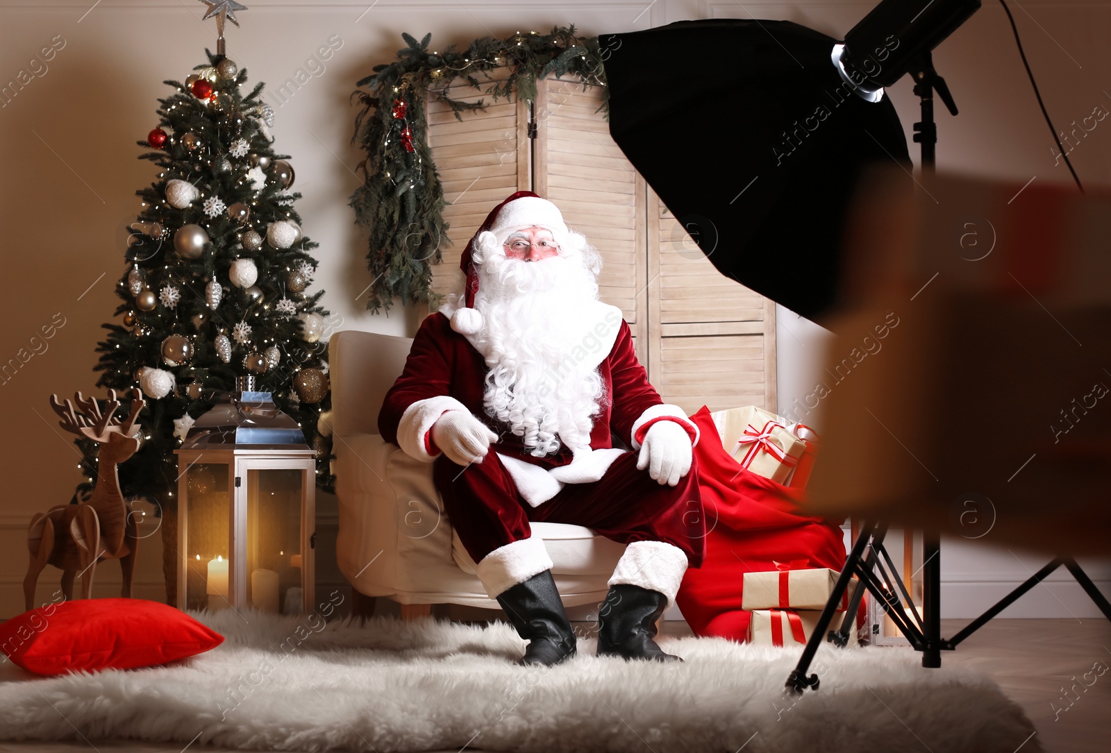 Photo of Santa Claus in photo zone decorated for Christmas