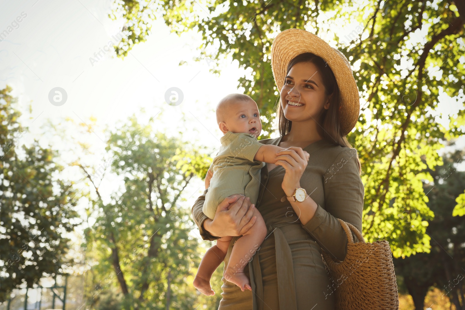 Photo of Young mother with her cute baby in park on sunny day