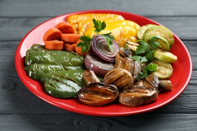 Delicious grilled vegetables on grey wooden table, closeup