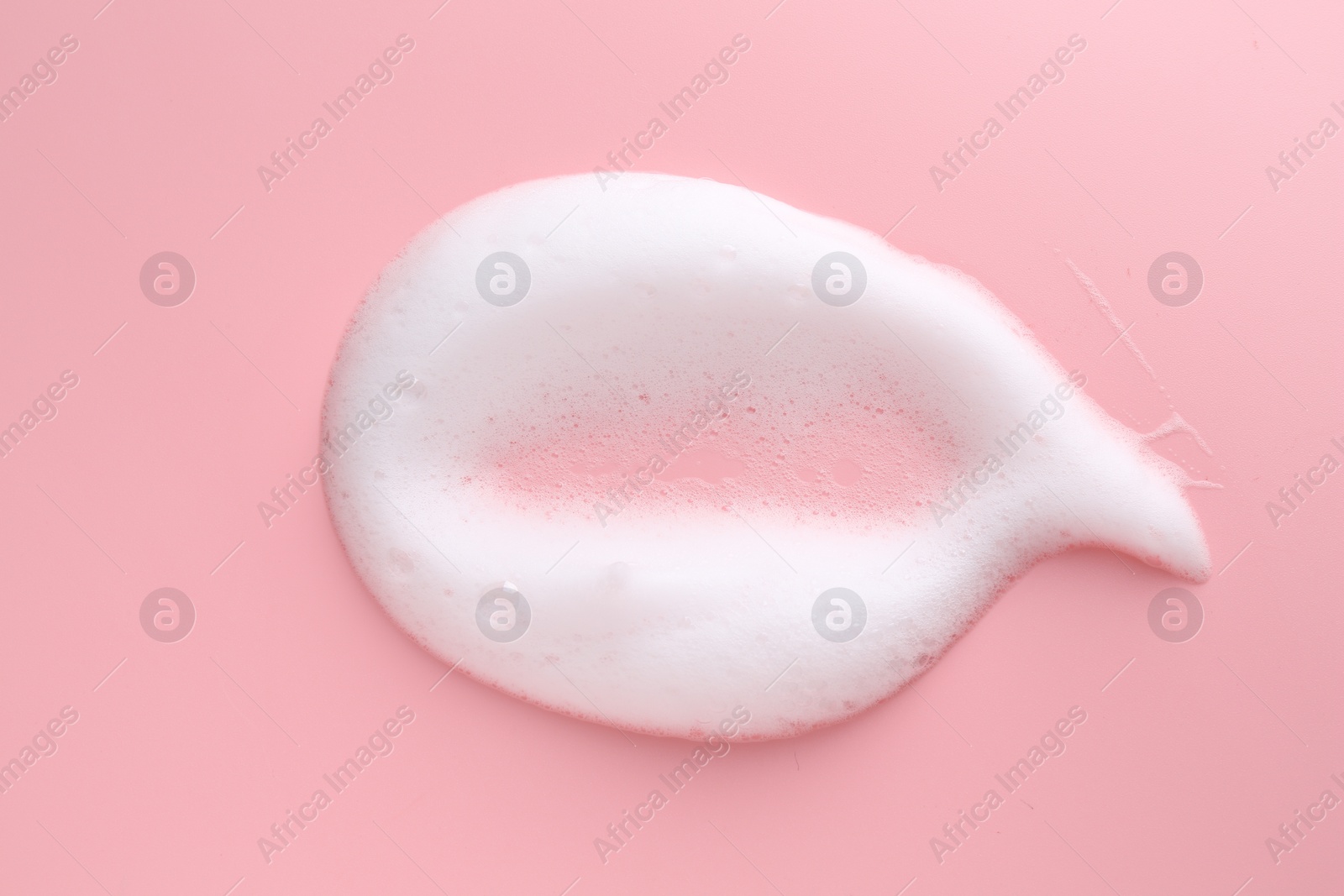 Photo of Sample of fluffy foam on pink background, top view