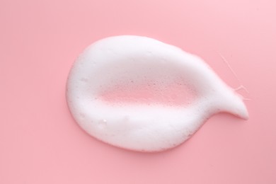 Sample of fluffy foam on pink background, top view