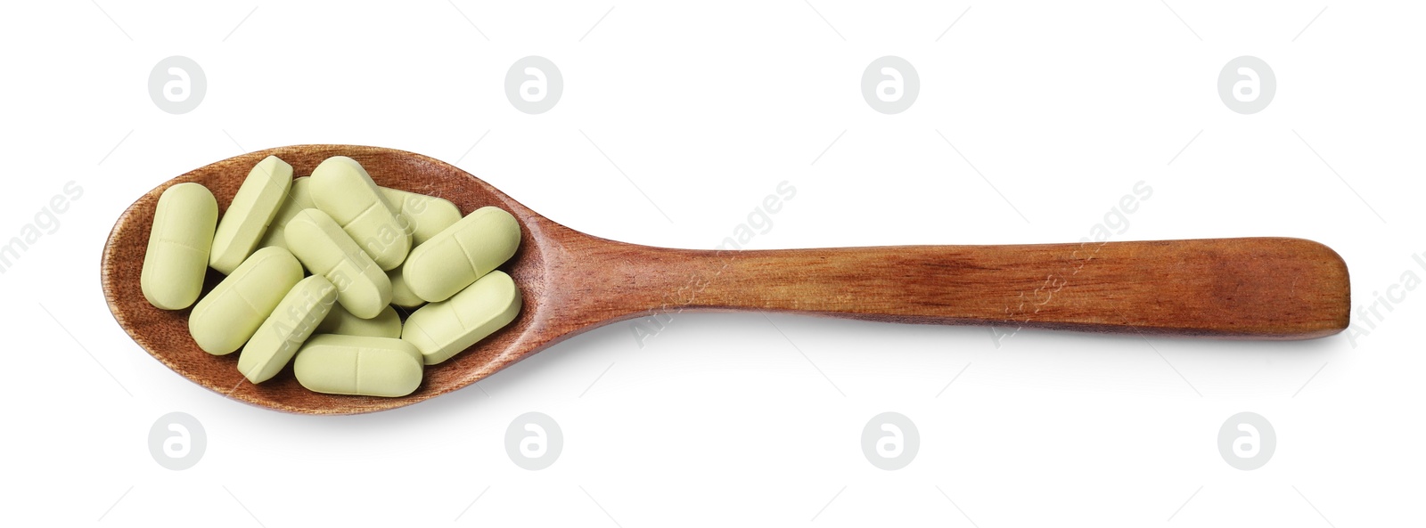 Photo of Vitamin capsules in wooden spoon isolated on white, top view