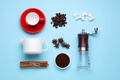 Photo of Flat lay composition with manual coffee grinder and spices on light blue background