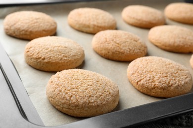 Delicious sugar cookies on baking sheet, closeup