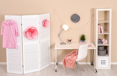 Photo of Cozy child room interior with study station and modern decor elements