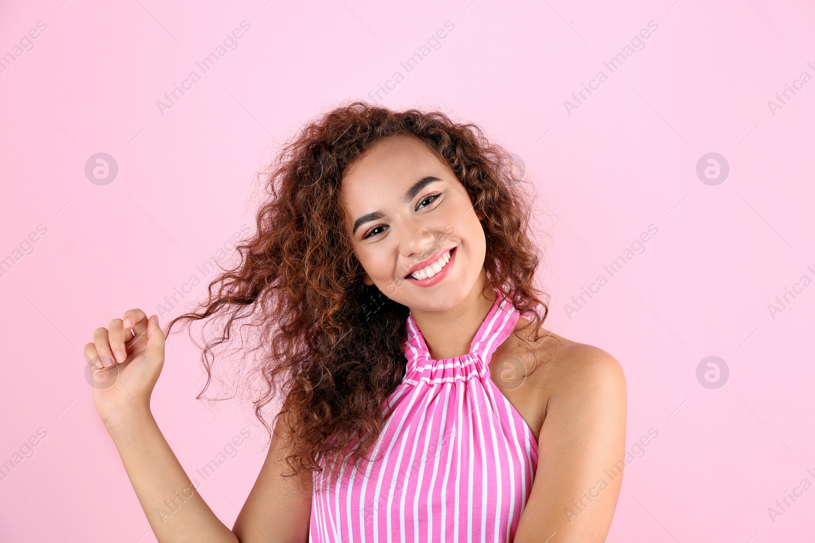 Photo of Portrait of young laughing African-American woman on color background