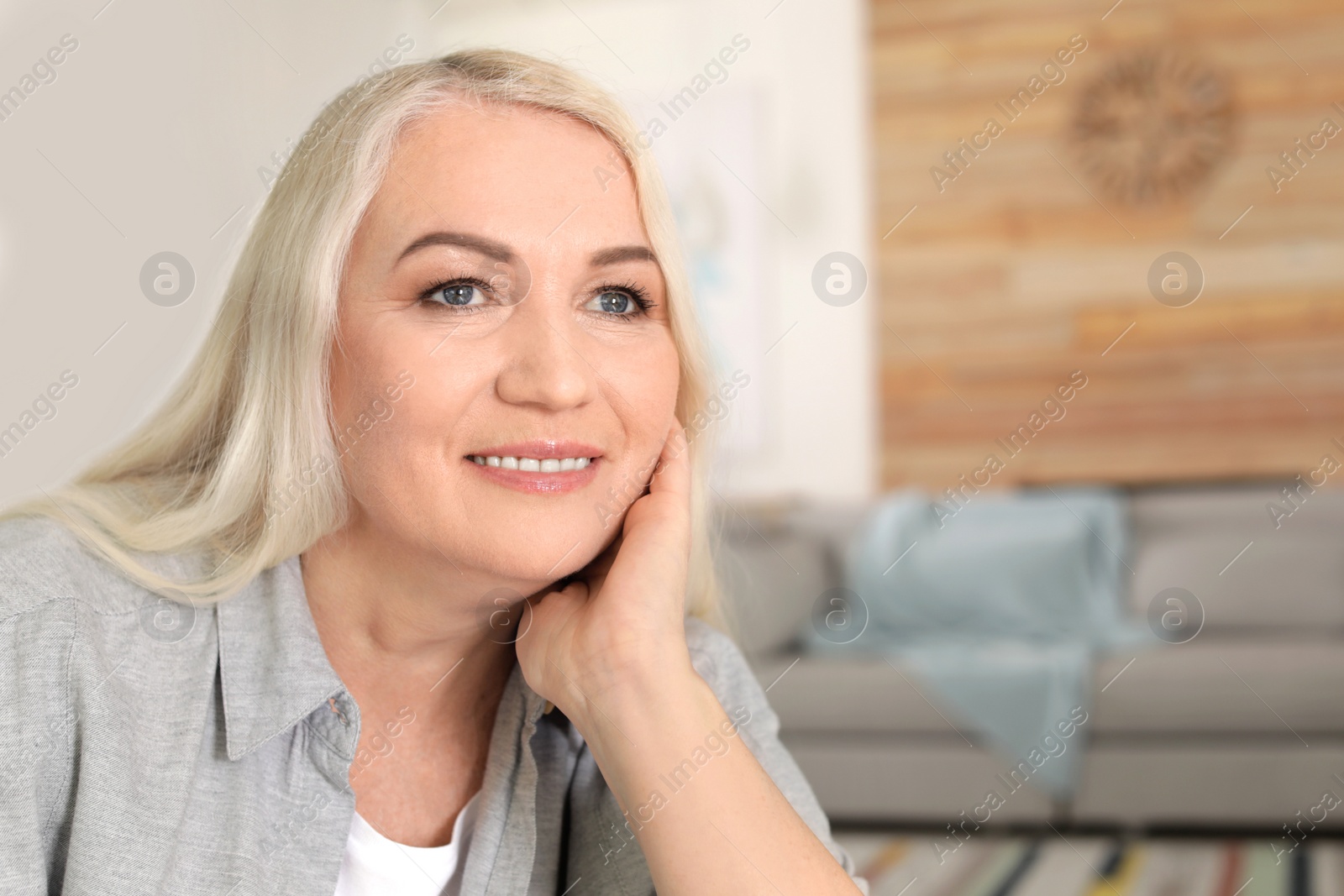 Photo of Portrait of mature woman in living room