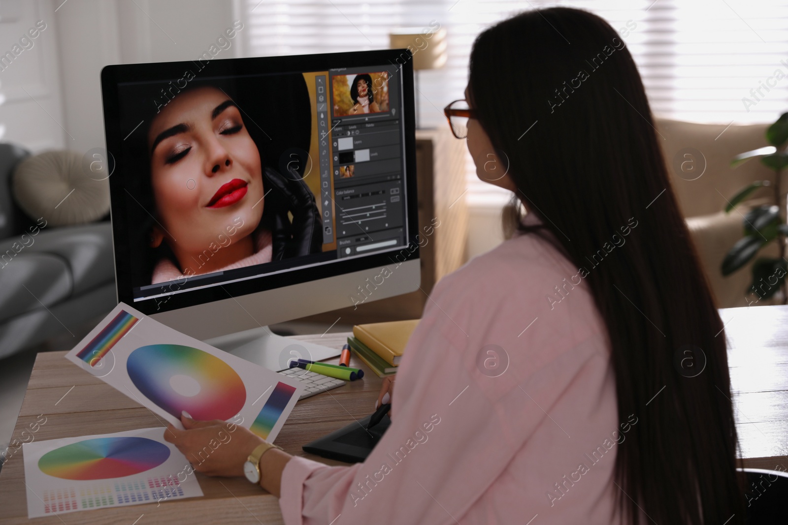 Photo of Professional retoucher working on computer in office