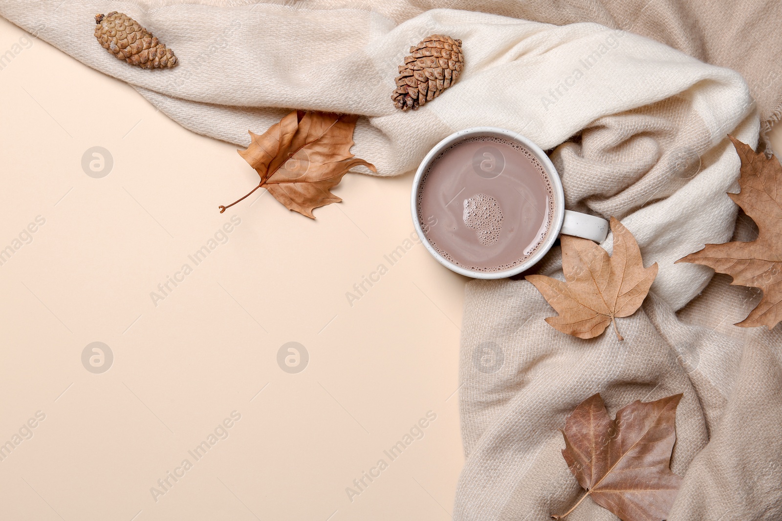 Photo of Flat lay composition with hot cozy drink and autumn leaves on color background. Space for text