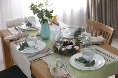 Photo of Beautiful Easter table setting with festive decor indoors