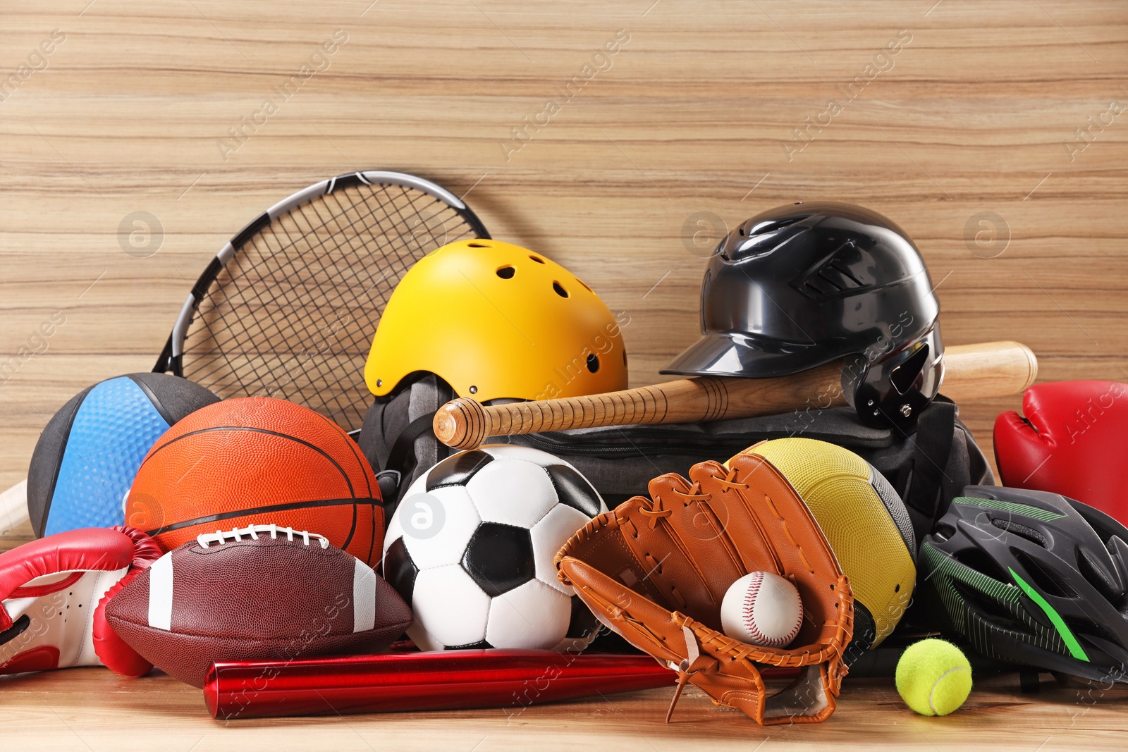 Photo of Many different sports equipment on wooden table