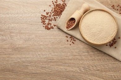 Photo of Bowl with buckwheat flour and seeds on wooden table, flat lay. Space for text