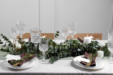 Photo of Luxury table setting with beautiful decor and blank cards indoors. Festive dinner