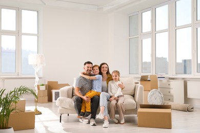 Happy family sitting on couch in new apartment. Moving day