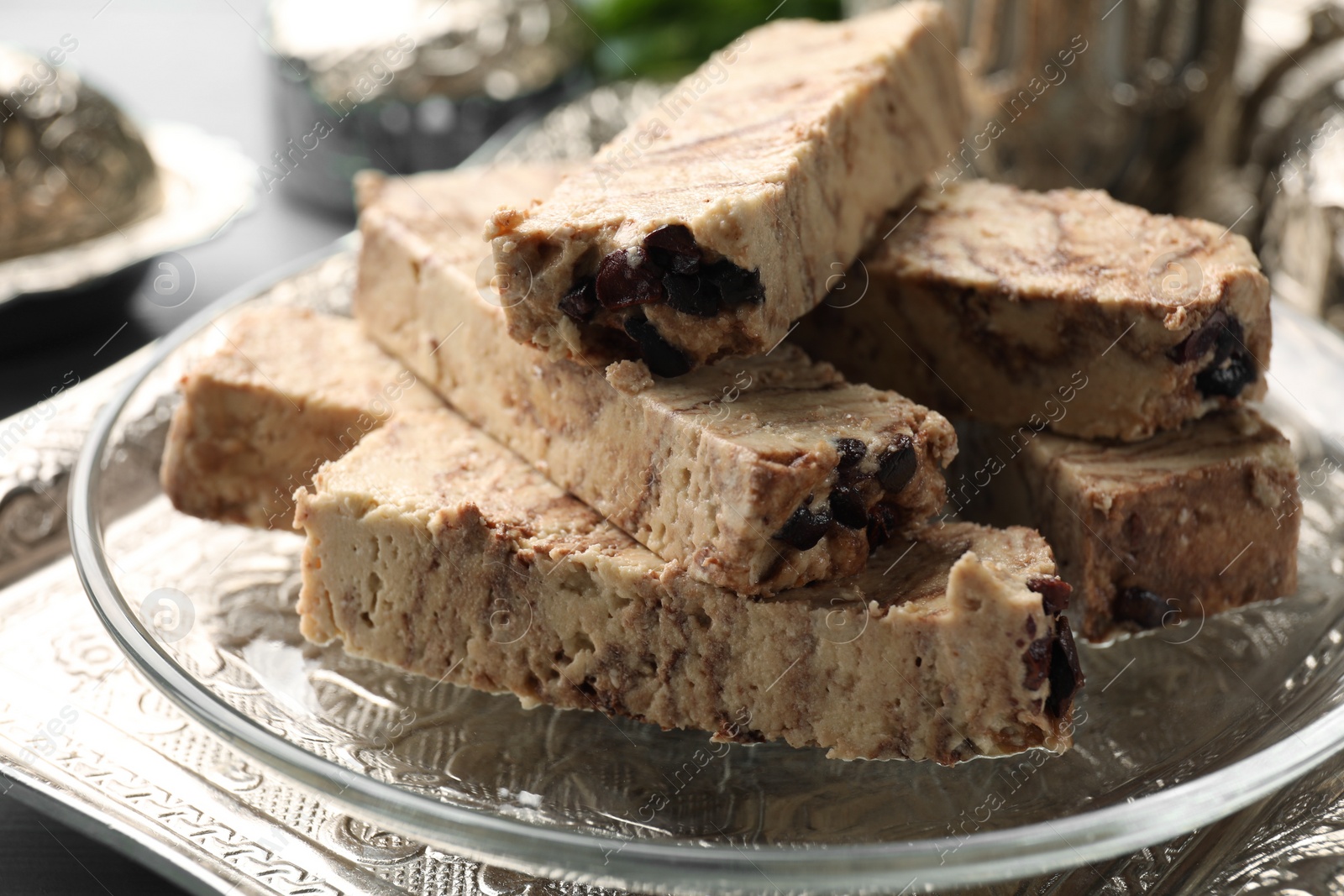 Photo of Pieces of tasty chocolate halva on tray, closeup