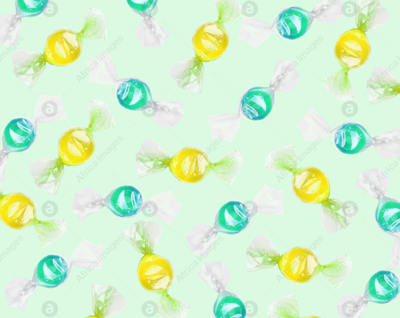 Image of Tasty candies on pale light green background. Pattern design