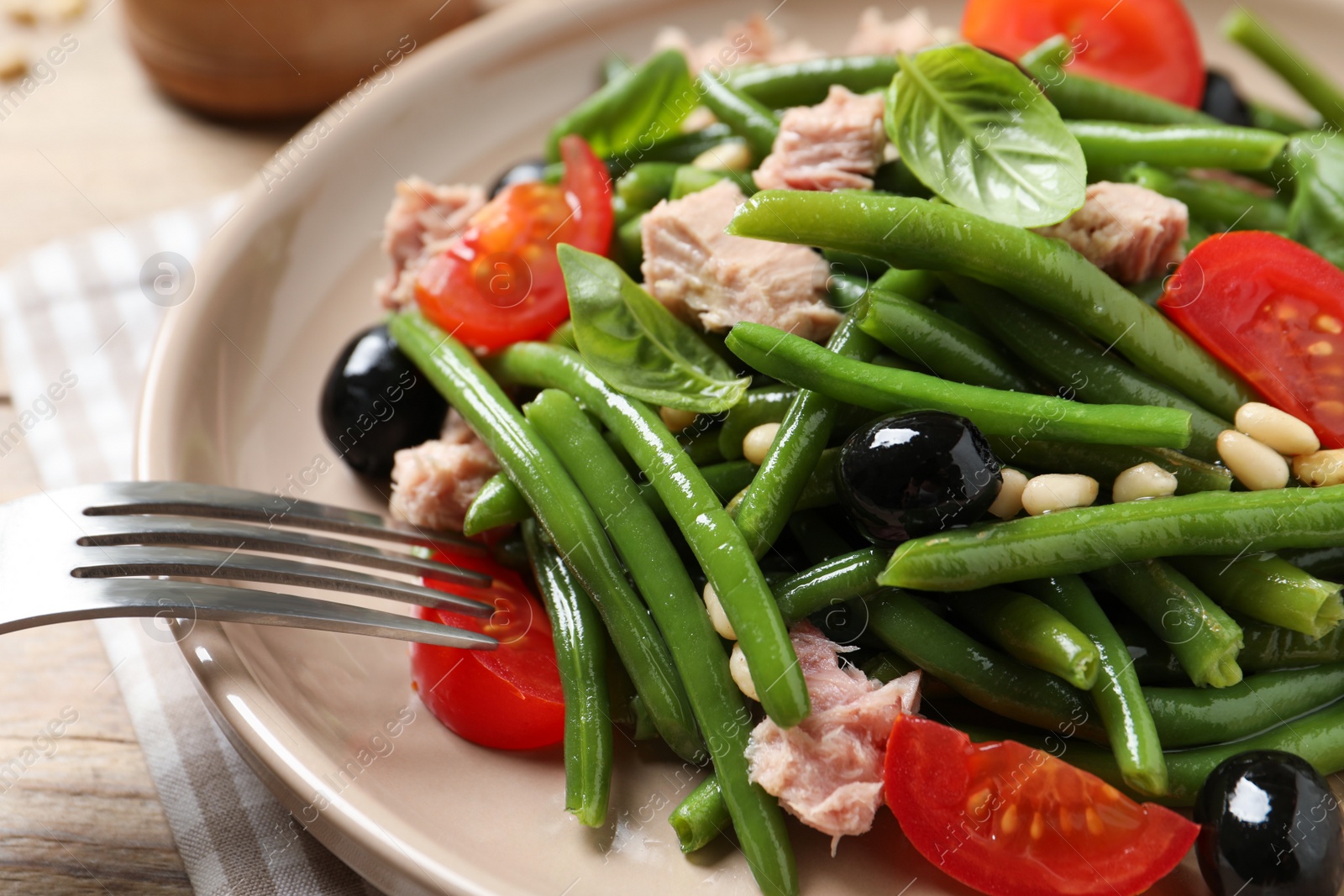 Photo of Tasty salad with green beans served on table, closeup