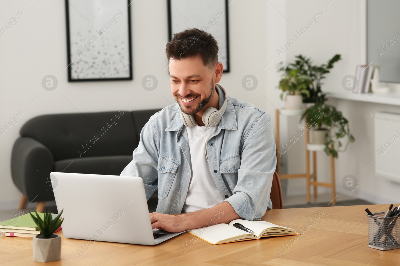 Photo of Online translation course. Man typing on laptop at home