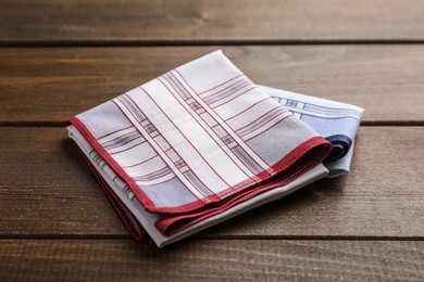 Photo of Handkerchiefs with patterns folded on wooden table