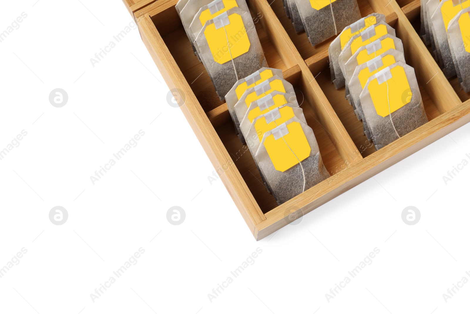 Photo of Paper tea bags with tags in wooden box on white background, above view