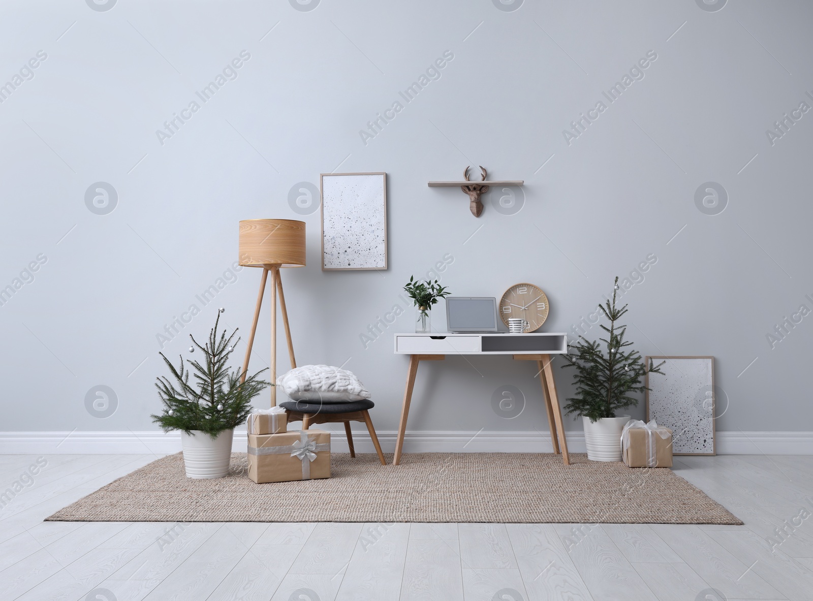 Photo of Stylish room interior with potted fir trees decorated for Christmas