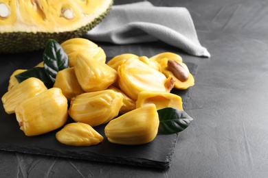 Delicious exotic jackfruit bulbs on grey table