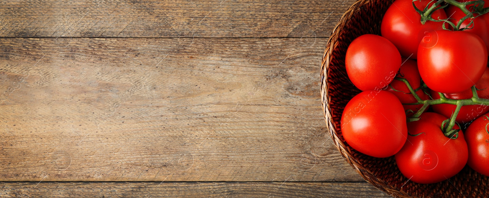 Image of Top view of bowl with fresh tomatoes on wooden, space for text. Banner design 