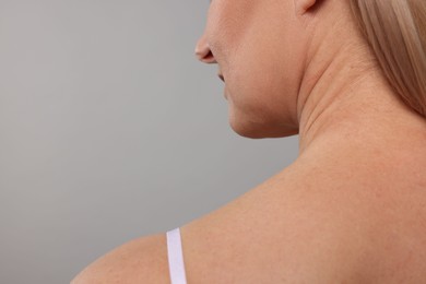 Photo of Woman with healthy skin on grey background, closeup