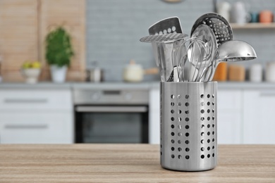 Photo of Different kitchen utensils on table