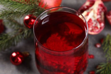 Photo of Aromatic Sangria cocktail in glass on grey table, closeup. Christmas drink